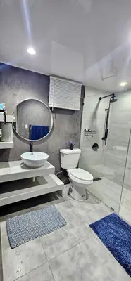 a bathroom with a toilet and a sink and a shower at Coco house by Julio in Nagua