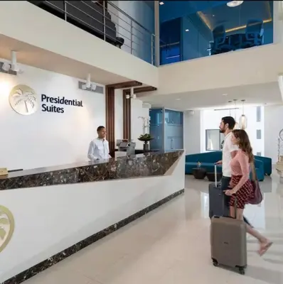 a group of people standing in a lobby with luggage at Imperial Suite 1-bedroom ocean view and kitchen in Cabarete