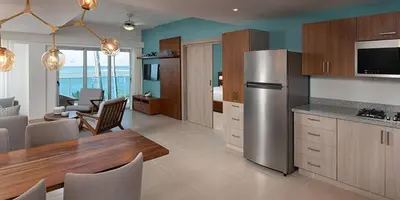a kitchen and dining room with a stainless steel refrigerator at Imperial Suite 1-bedroom ocean view and kitchen in Cabarete