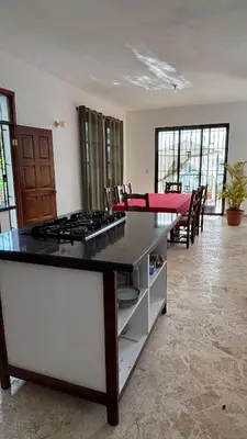 a kitchen with a counter with a stove top at Villa Aurora Samaná in Santa Bárbara de Samaná