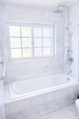 a white bathroom with a tub and a window at Villa Wolf in Punta Cana