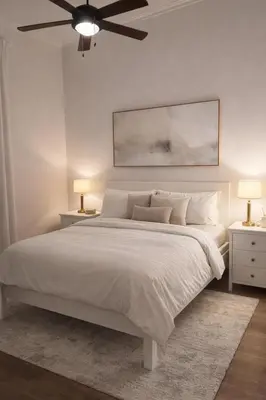 a white bedroom with a large bed with two night stands at Villa Wolf in Punta Cana