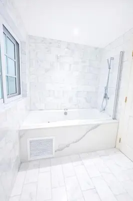 a white bathroom with a tub and a window at Villa Wolf in Punta Cana