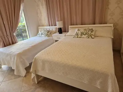 a bedroom with two beds and a window at Big & classy condo at Cocotal Golf & Beach in Punta Cana