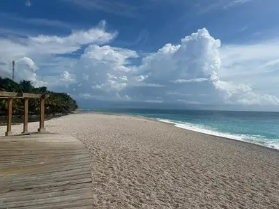 a wooden boardwalk on a beach near the ocean at 2 Bdrm 1 Bath Near River and Beach, 3L, Paraiso, Barahona in Paraíso