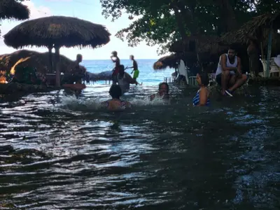 a group of people in the water at a beach at 2 Bdrm, 1 Bath, Wifi, Near River and Beach, 3R, Paraiso, Barahona in Paraíso
