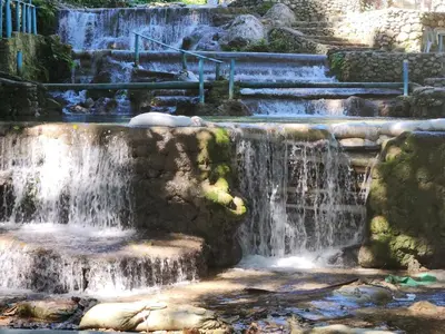 a waterfall in a park with rocks and stairs at 2 Bdrm, 1 Bath, Wifi, Near River and Beach, 4R, Paraiso, Barahona in Paraíso