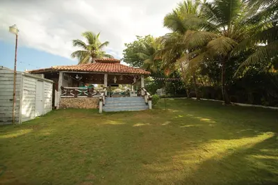 a house with a gazebo in a yard at Horizonte Marino En De Franchecis Hostal in Juan Dolio