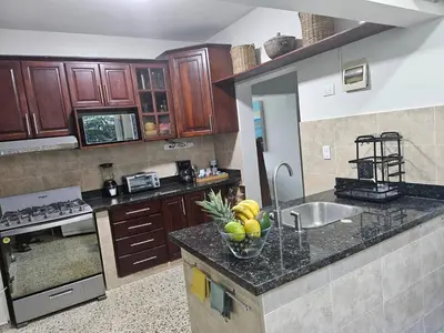 a kitchen with a bowl of fruit on a counter at Beautiful Oceanfront Apartment Private Balcony in San Felipe de Puerto Plata