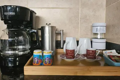 a counter top with coffee cups and a coffee maker at Beautiful Oceanfront Apartment Private Balcony in San Felipe de Puerto Plata