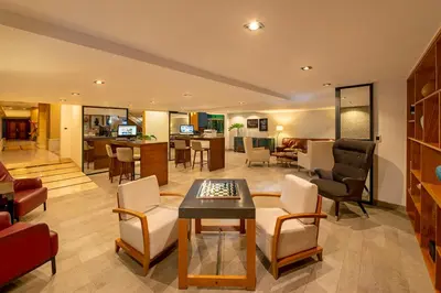 a living room with a table and chairs at Catalonia Santo Domingo in Santo Domingo