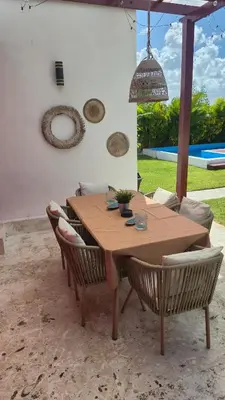 a wooden table and chairs in a patio at Wohlfühloase in der Karibik in Punta Cana