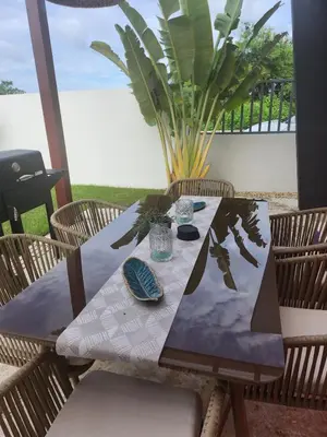 a wooden table with chairs and a table cloth on a patio at Wohlfühloase in der Karibik in Punta Cana