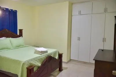 a bedroom with a bed and a dresser at Hotel la playa in Santa Cruz de Barahona