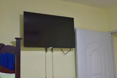 a flat screen tv on top of a refrigerator at Hotel la playa in Santa Cruz de Barahona