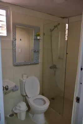 a bathroom with a toilet and a shower at Hotel la playa in Santa Cruz de Barahona