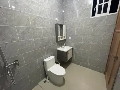 a bathroom with a toilet and a mirror at Villa A&J in Santa Cruz de Barahona