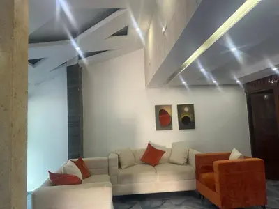 a living room with a couch and some paintings at Comodidad, descanso y una vista que inspira in Miches