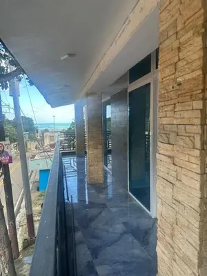 a building with a balcony with a stone wall at Comodidad, descanso y una vista que inspira in Miches