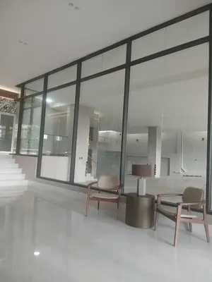 a room with two chairs and a table and windows at a wonderful apt, close to everything you need in Santo Domingo