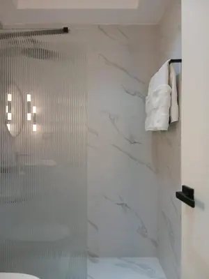 a bathroom with a shower with a glass door at a wonderful apt, close to everything you need in Santo Domingo