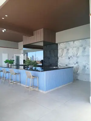 a kitchen with a blue counter and stools at a wonderful apt, close to everything you need in Santo Domingo