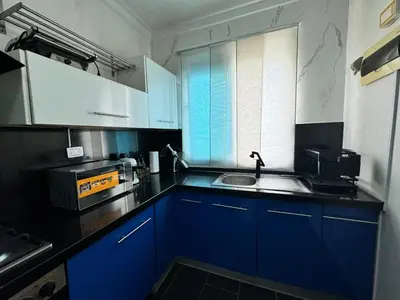 a kitchen with blue cabinets and a sink at Dreamvillage in Boca Chica