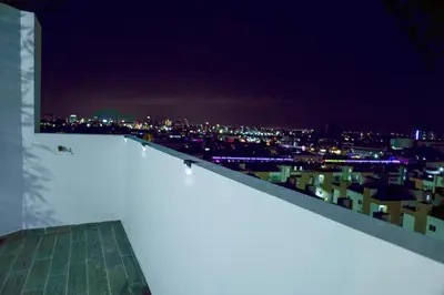 a view of a city at night from a building at Best Loft In The Heart of Santo Domingo Este in Juan López