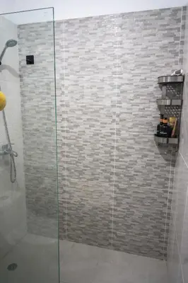 a bathroom with a shower with a glass door at Best Loft In The Heart of Santo Domingo Este in Juan López