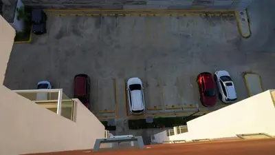 an overhead view of cars parked in a parking lot at Best Loft In The Heart of Santo Domingo Este in Juan López