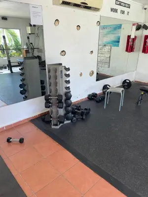 a gym with a bunch of equipment on the wall at Oceanfront apartment with views and pool in Los Corrales