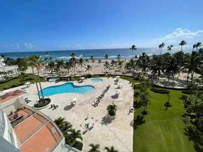 an aerial view of a resort with a pool and the ocean at Oceanfront apartment with views and pool in Los Corrales