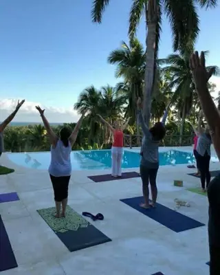 a group of people doing yoga by a pool at Grandi spazi vista mare piscina infinity con grotta taina in Las Terrenas