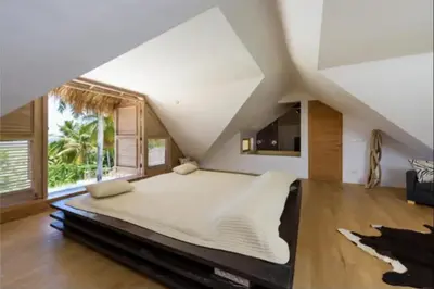 a large bedroom with a large bed and a large window at Grandi spazi vista mare piscina infinity con grotta taina in Las Terrenas