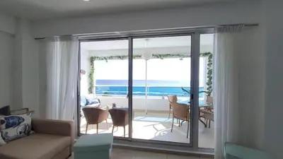 a living room with a view of the ocean at Beach Front Condo!