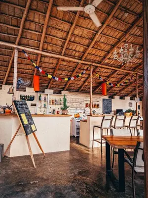a restaurant with tables and chairs in a room at Hotel Enjoy in Las Terrenas