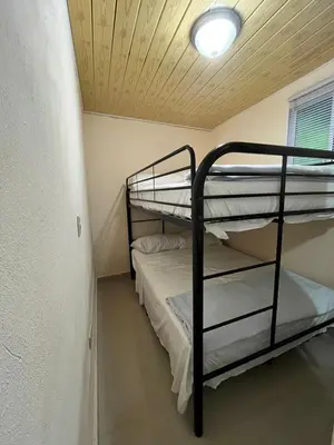 two bunk beds in a small room with a ceiling at Mirador de las Nubes in Jarabacoa