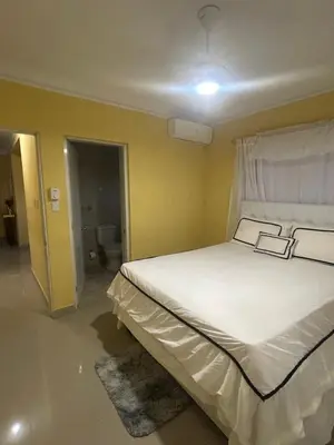 a bedroom with a bed with two books on it at Garden view paradise in Concepción de La Vega