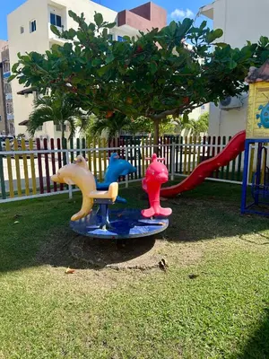 a playground with three play equipment in the grass at Garden view paradise in Concepción de La Vega
