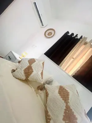 a bed with two pillows on top of it at Residencial Larimar 1 - Steps from Bayahíbe Beach in Bayahibe