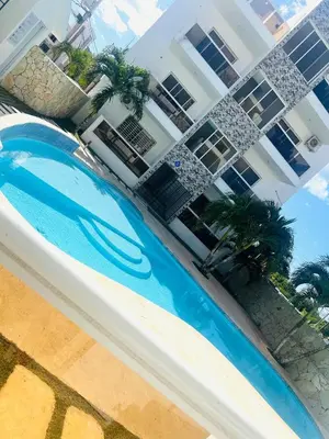 an overhead view of a swimming pool in front of a building at Residencial Larimar 1 - Steps from Bayahíbe Beach in Bayahibe