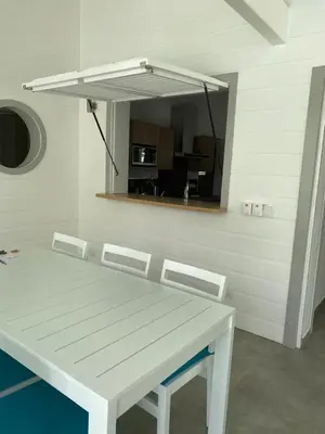 a white table and chairs in a room with a mirror at Villa Exceptional location - Las Ballenas in Las Terrenas