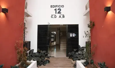 a hallway of a building with a sign on the wall at Relaxing & New Retreat 3 bedroom riviera Verde in Santo Domingo