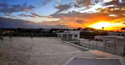 a sunset on the roof of a building at Villa Jasmine Ocean Village in Sosúa