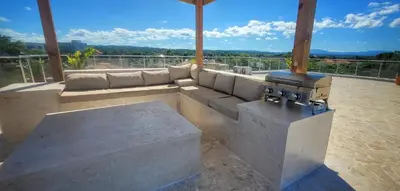 a living room with a couch and a stove at Apt Jasmine Ocean Village in Sosúa