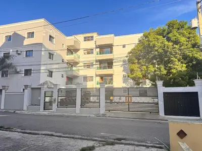 a white building with a fence in front of it at Enjoy Huge 4 bedrooms, and 3 bathrooms, 8 new apartments in Santiago de los Caballeros