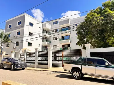 a truck parked in front of a white building at Enjoy Huge 4 bedrooms and 3 bathrooms in Santiago de los Caballeros