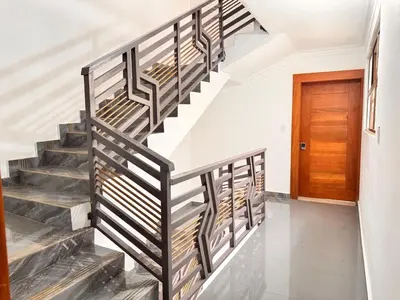 a staircase in a house with a wooden door at NEW 8apts enjoy HUGE 4 bedrs in Santiago de los Caballeros