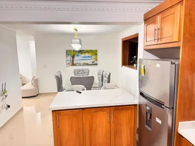 a kitchen with a refrigerator and a dining room at NEW 8apts enjoy HUGE 4 bedrs in Santiago de los Caballeros