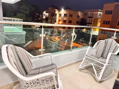 two chairs sitting on top of a balcony at NEW 8apts enjoy HUGE 4 bedrs in Santiago de los Caballeros